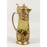 AN ART NOUVEAU LIDDED JUG with green tinted glass body and naturalistic gilt metal mounts. 14ins