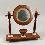 A VICTORIAN SHAVING MIRROR on a stand. 13.4ins.