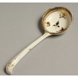 AN 18TH CENTRUY CAUGHLEY LADLE decorated in blue and gilt.