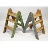 A PAIR OF FOLDING WOODEN STEPS decorated to the sides with Champagne producers. 32ins high
