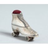 A CAST SILVER ROLLER SKATE PIN CUSHION.