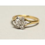 A 14CT GOLD AND DIAMOND CLUSTER RING