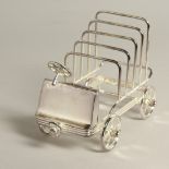 A SILVER PLATE VINTAGE CAR FOUR DIVISION TOAST RACK.