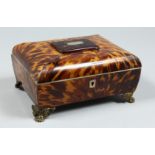 A GOOD TORTOISESHELL SEWING BOX with fitted interior, mirror in the lid, on claw feet. 8.5ins high.