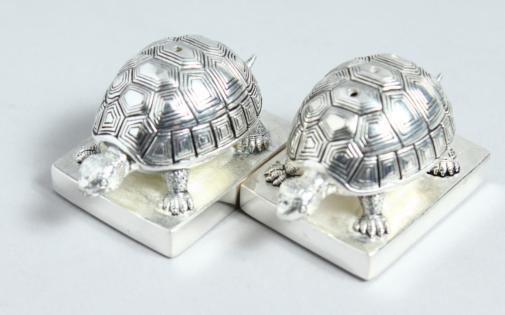 A PAIR OF .800 TORTOISE SALT AND PEPPERS.