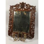 A GOOD EARLY CARVED OAK MIRROR - GIRENDOLE with fittings and bevelled edge mirror. 28ins x 22ins.
