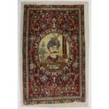 A SMALL PERSIAN MAT / WALL HANGING woven with a portrait of the King of Persia. Overall size 2ft 9.