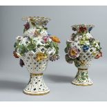 A PAIR OF MEISSEN PORCELAIN BALLUSTER SHAPED VASES, with pierced bodies and floral encrusted