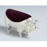 A LARGE WHITE METAL PIG PIN CUSHION