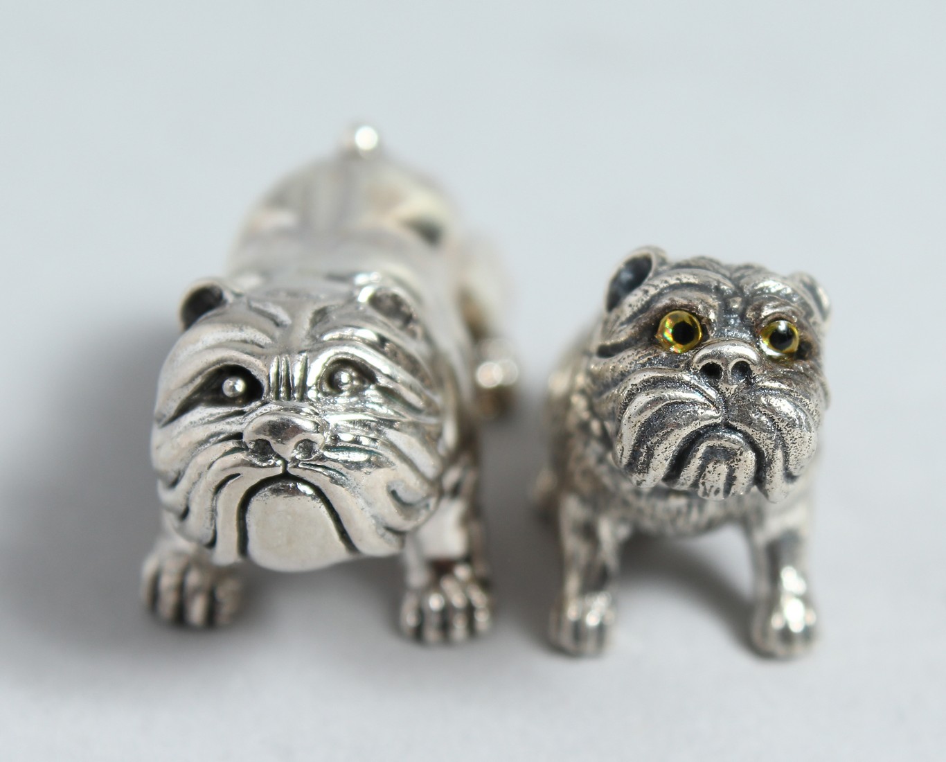 A SILVER PAIR OF CAST SILVER FIGURES OF DOGS.