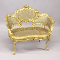 A SMALL FRENCH GILTWOOD CANAPE, with carved decoration, canework back and seat on cabriole legs. 3ft