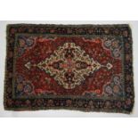 A PERSIAN BAKHTIARI CARPET, red ground with a beige ground, central lozenge shape panel. 6ft 3ins