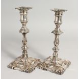 A PAIR OF OLD SHEfFIELD PLATE CANDLESTICKS. 9ins high.