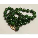 A JADE NECKLACE with gold clasp