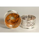 A PAIR OF SILVER PLATE AND FAUX TORTOISESHELL CIRCULAR WINE COASTERS.