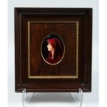 A FRAMED LINOGES ENAMEL PLAQUE, HEAD AND SHOULDERS OF A YOUNG LADY. 4.5ins x 3ins Signed and