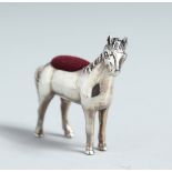 A CAST SILVER PONY PIN CUSHION.