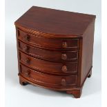 A MINIATURE MAHOGANY BOW FRONT CHEST OF DRAWERS, four long graduated drawers with wooden handles