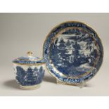 AN 18TH CENTRUY CAUGHLEY SUCRIER AND COVER in the Pagoda pattern and a matching saucer dish (3).