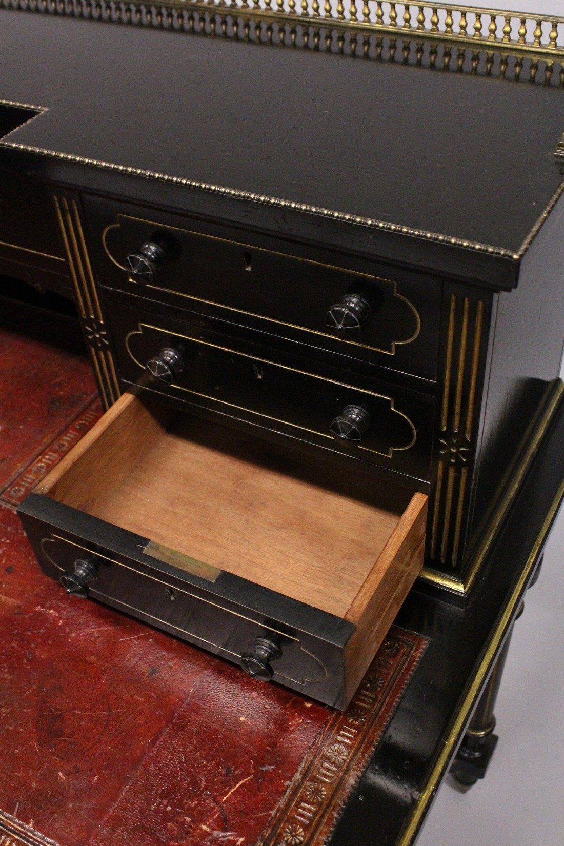 GILLOW & CO. AN EBONISED AND PARCEL GILDED WRITING DESK, the brass galleried upper section fitted - Image 6 of 7