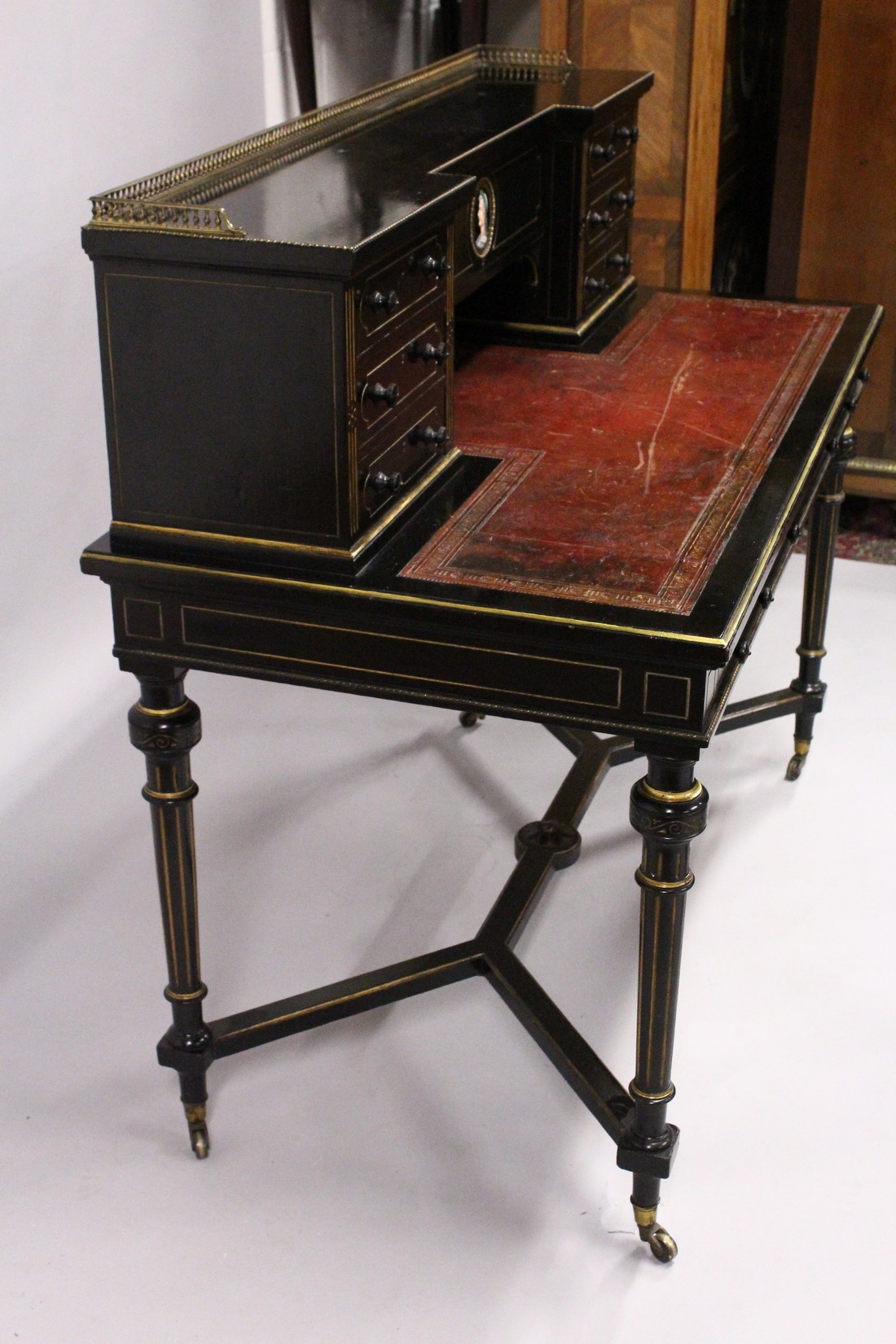 GILLOW & CO. AN EBONISED AND PARCEL GILDED WRITING DESK, the brass galleried upper section fitted - Image 7 of 7