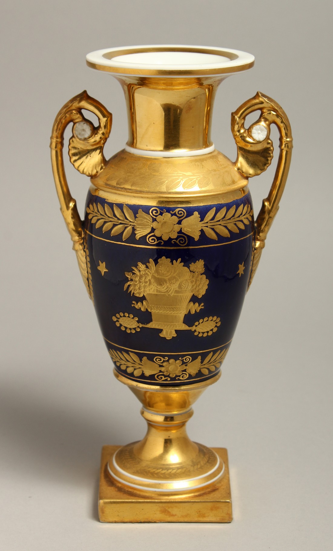 A 19TH CENTURY PARIS PORCELAIN TWO HANDLED VASE having a cobalt blue ground with etched gilded