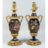 A PAIR OF PARIS PORCELAIN AND ORMOLU MOUNTED URN SHAPED TABLE LAMPS, painted with panels of