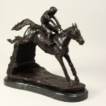 A BRONZE HORSE AND JOCKEY JUMPING A FENCE, No. 3, on a metal base. 13ins high.