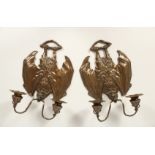 A PAIR OF BRONZE BATS' WING SCONCES with two candle branches