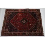 A PERSIAN QASHQAI CARPET, red ground with large central medallion. 10ft x 7ft 5ins.