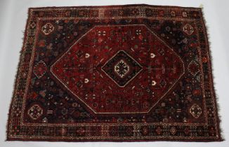 A PERSIAN QASHQAI CARPET, red ground with large central medallion. 10ft x 7ft 5ins.