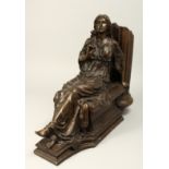 A CLASSICAL BRONZE OF A SEATED YOUNG LADY holding a rose, beside a column. 18ins long.