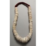 A TRIBAL SHELL NECKLACE.
