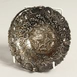A DUTCH SILVER CIRCULAR BASKET with pierced decoration repousse with a man smoking a pipe.