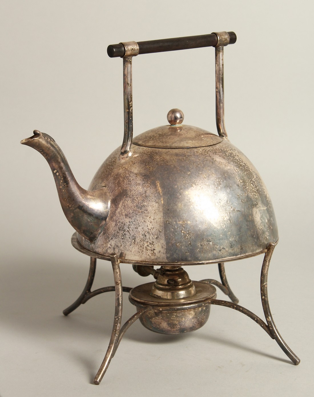 AN ARTS AND CRAFTS SILVER PLATED TEA KETTLE ON STAND after a design by CHRISTOPHER DRESSER, circa.