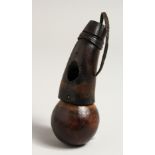 A TRIBAL WOODEN SNUFF BOTTLE OR POWDER FLASK. 5.25ins long.