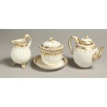 A COALPORT TETE-A-TETE TEA SERVICE with gilded decoration having a small teapot and cover with