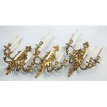 A SET OF THREE, FIVE BRANCH WALL APPLIQUES each with urn finial, female mask back plates and