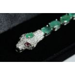 A SILVER EMERALD SNAKE LINE BRACELET.