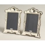A PAIR OF SILVER SERPENTINE TOP PHOTOGRAPH FRAMES. 8ins x 6.5ins.