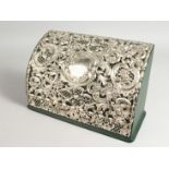 A STERLING SILVER AND GREEN LEATHER STATIONERY CASKET, the hinged cover with profusely pierced and