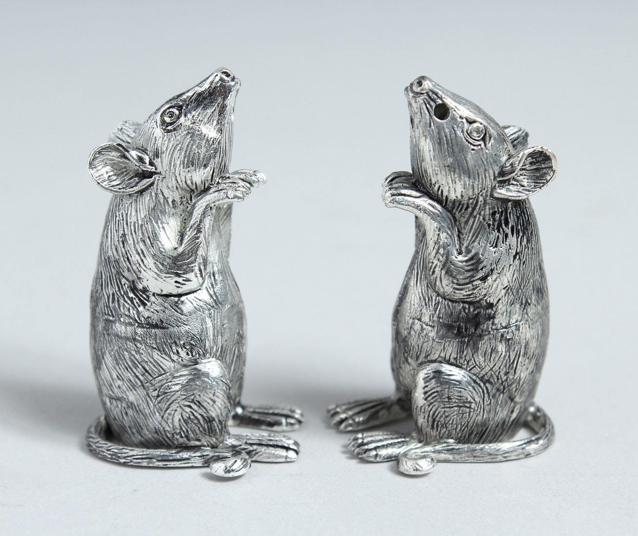 A PAIR OF .800 MICE SALT AND PEPPERS