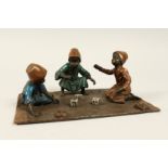 A VIENNA COLD PAINTED BRONZE GROUP, boys playing dice. 7.5ins x 5ins