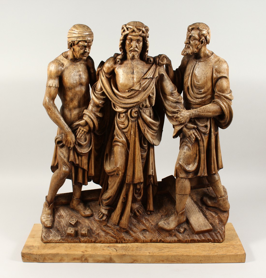 A SUPERB 18TH CENTURY GERMAN, CARVED LIMEWOOD GROUP, CHRIST with two men, the base with a cross
