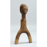 AN EARLY WOODEN FIGURE 7ins long.