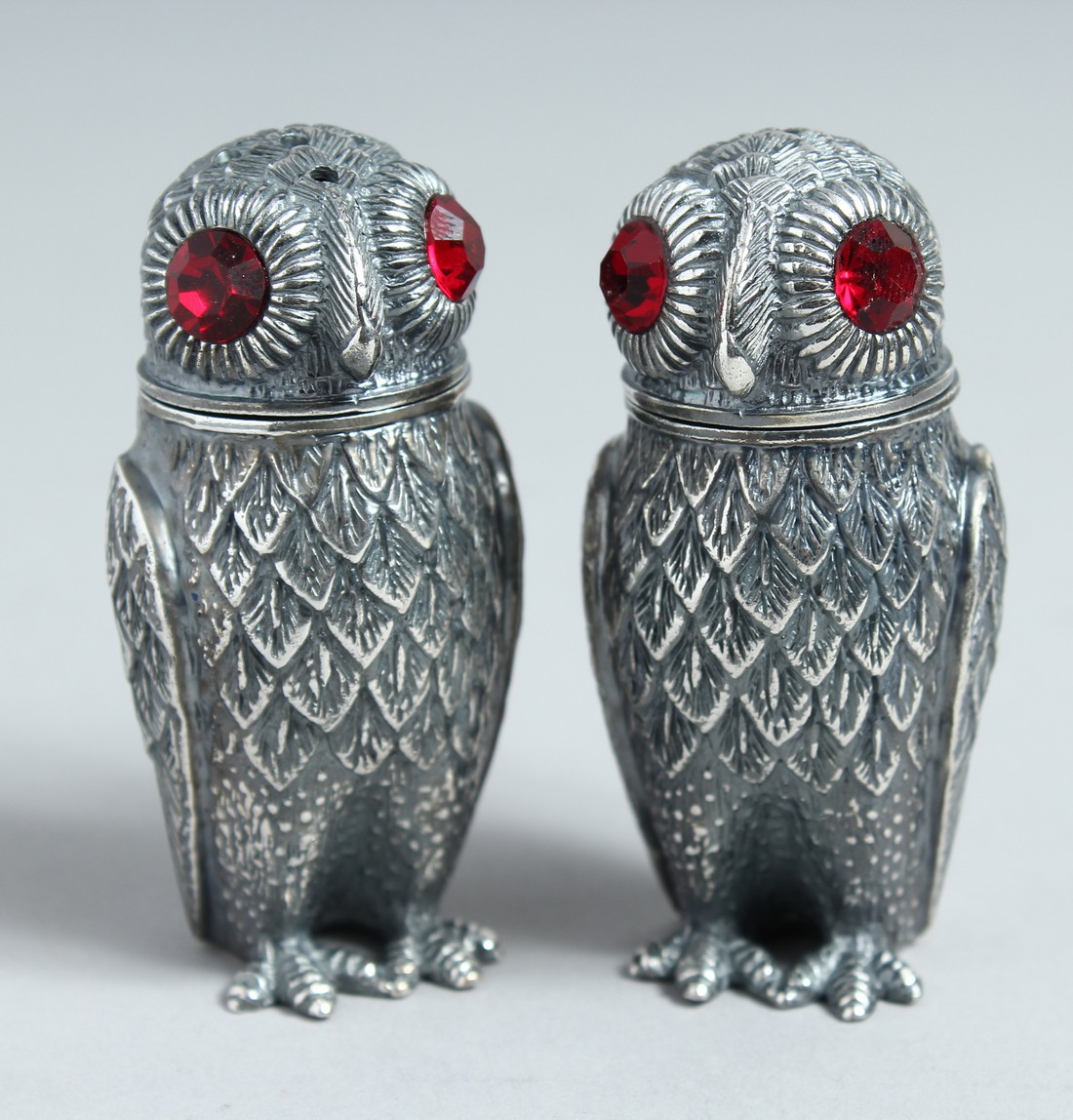 A PAIR OF .800 OWL SALT AND PEPPERS