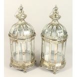 A PAIR OF METAL AND GLASS LANTERNS.