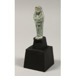 AN EGYPTIAN SHABTI on stand, 3ins high.