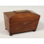 A LATE REGENCY MAHOGANY TWO DIVISON TEA CADDY on bun feet. 8ins high.