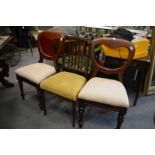 A pair of Victorian mahogany dining chairs and another chair.